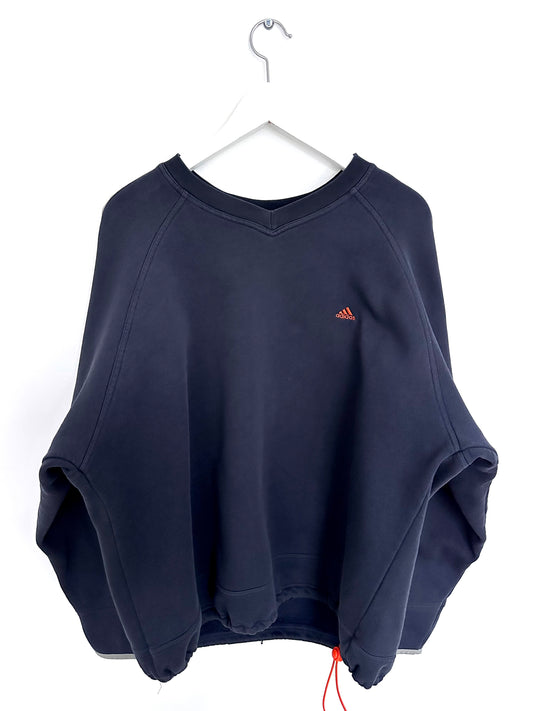 Navy blue vintage sweatshirt with a orange Adidas logo on a white hanger