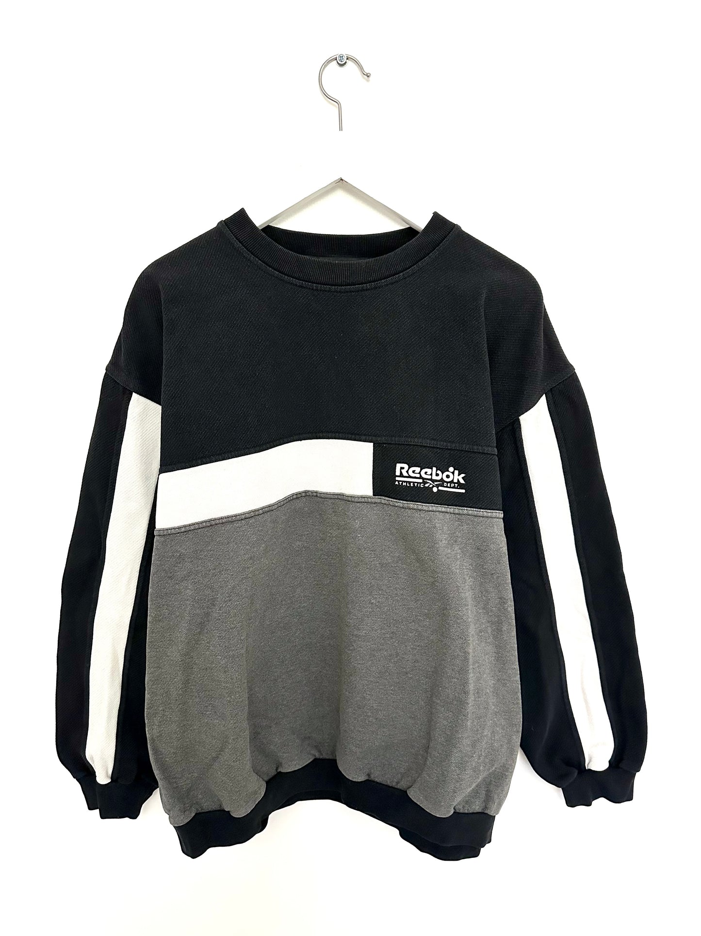 Black and gray sweatshirt with a Reebok logo on a white background